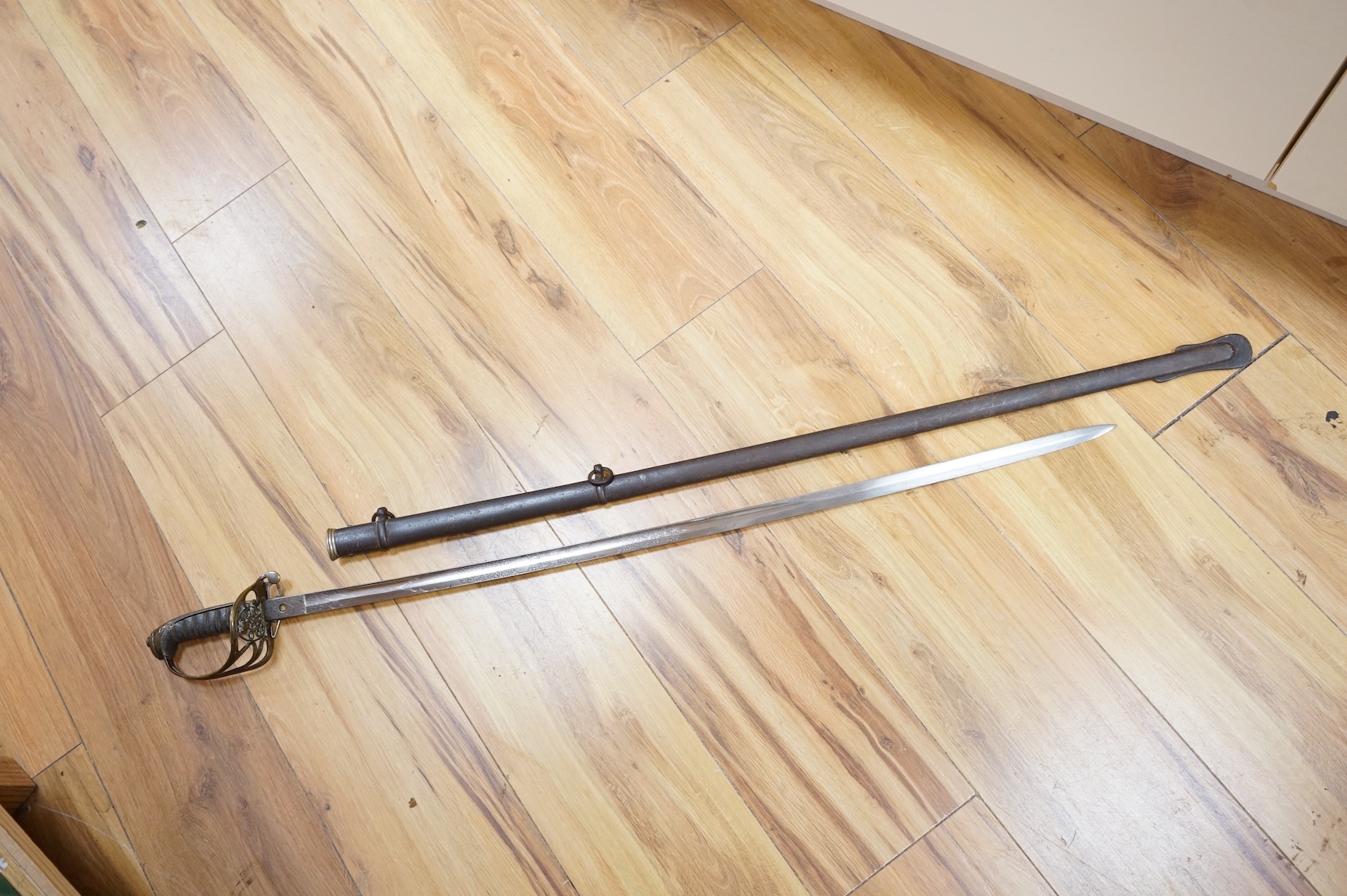 A Victorian 1845 pattern infantry officer’s levee sword, with slender blade etched; Hamburger Rogers & Co., and crowned VR and foliage, regulation pierced brass guard with folding side guard, wire bound fish skin covered